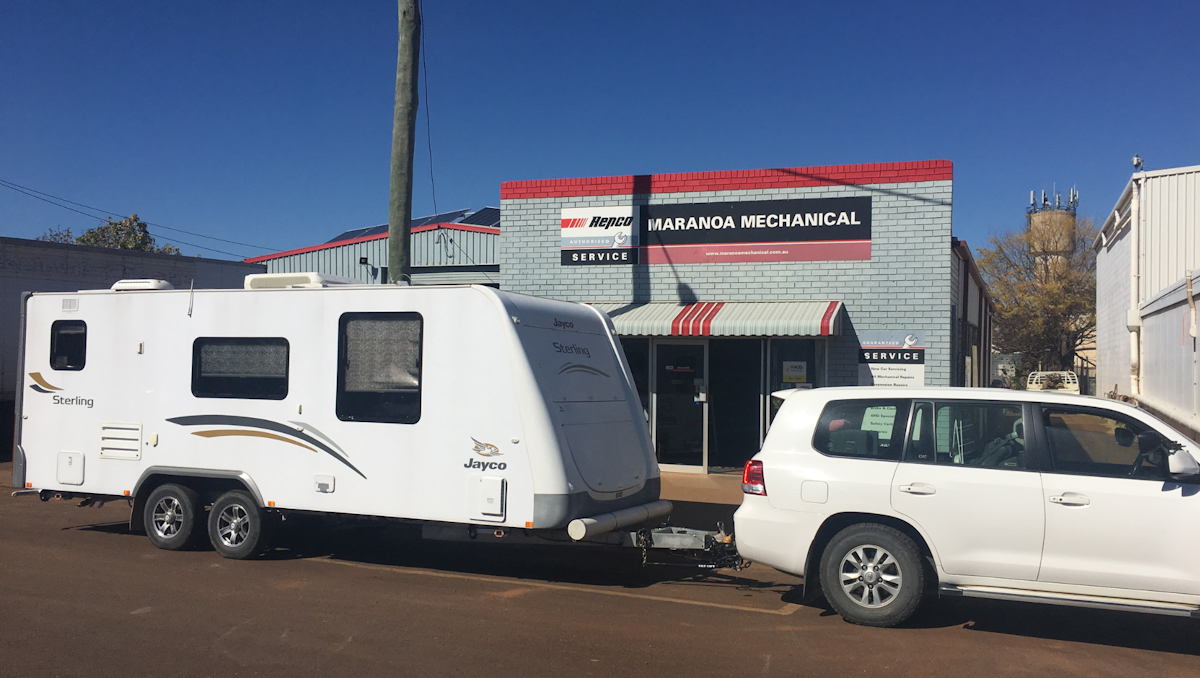 Caravan and car parked in front of Maranoa Mechanical workshop